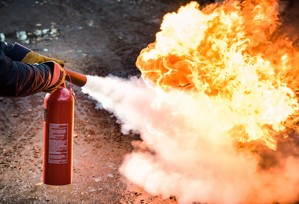 A man using a carbon dioxide fire extinguisher to fight a fire