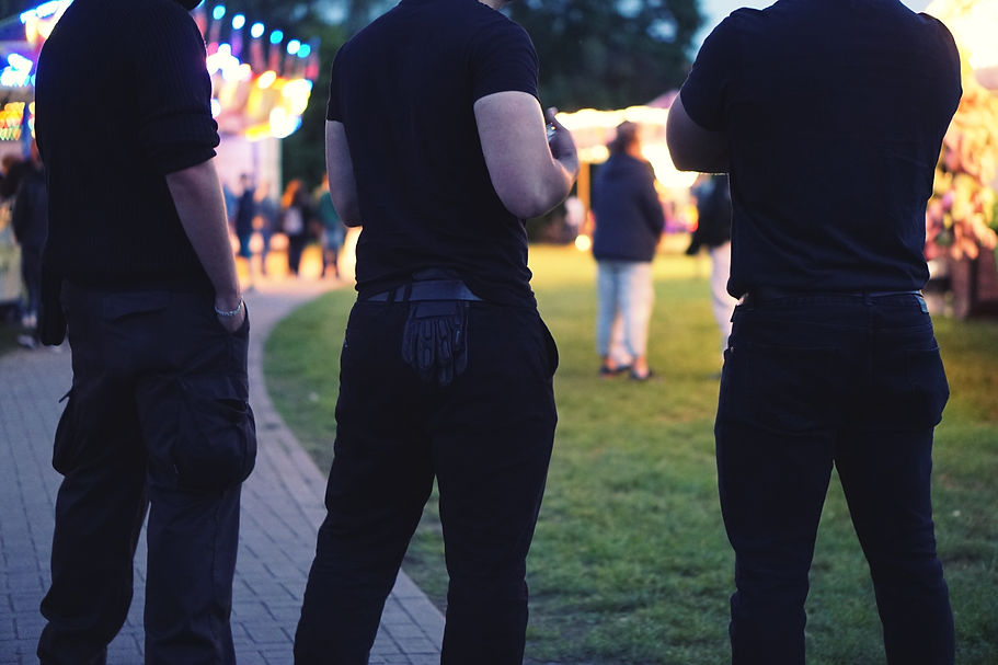 Midsection Of Bouncers Standing At Garden Party
