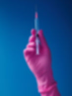 Syringe with pink glove