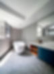 A renovated bathroom with a white bathtub and a window
