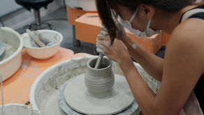 Person shapes clay on a spinning potter’s wheel—capturing how mindful focus can calm the chaos of living with anxiety.