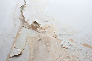 Peeling paint and water damage on a wall