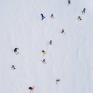 Aerial view of skiers and snowboarders on the groomed winter trails of the Mount Hermon ski site.