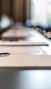A photo of a conference table set for a meeting