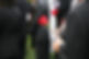 A person with a red rose at a funeral