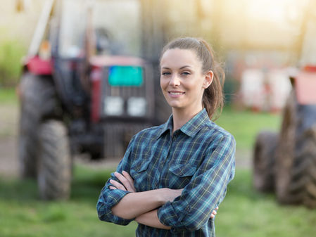 Young farmer working to manage her costs of production.