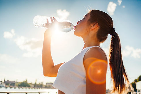 A picture of a women running and exercising beneath a clear sky