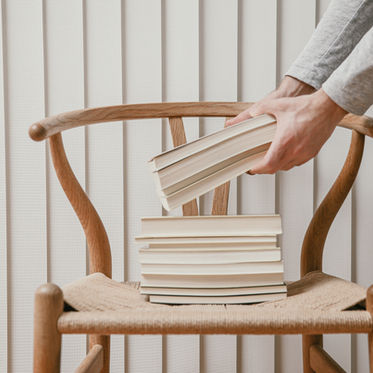 stack of books sitting on a chair