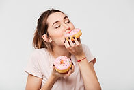 Woman Eating Donuts