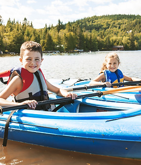 Children Kayaking on River