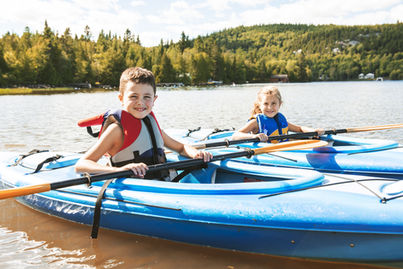Children Kayaking on River