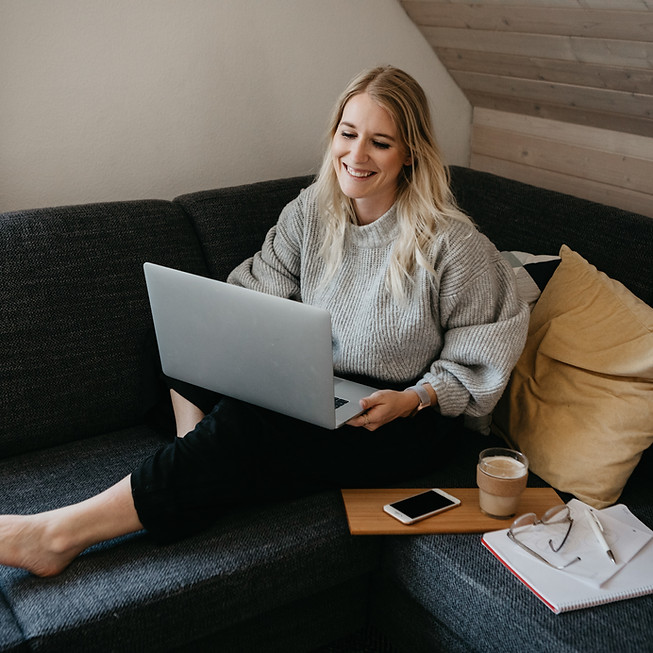 Person sitting on couch with laptop