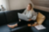 Person sitting on couch with laptop