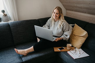 Person sitting on couch with laptop
