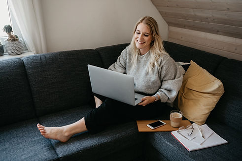Person sitting on couch with laptop