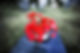 Bouquet of vibrant red roses in a vase on a gravestone with "In Loving Memory" inscribed