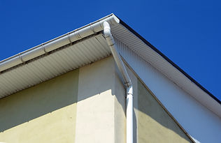 Rain gutters on a house. White gutter on the roof top of house