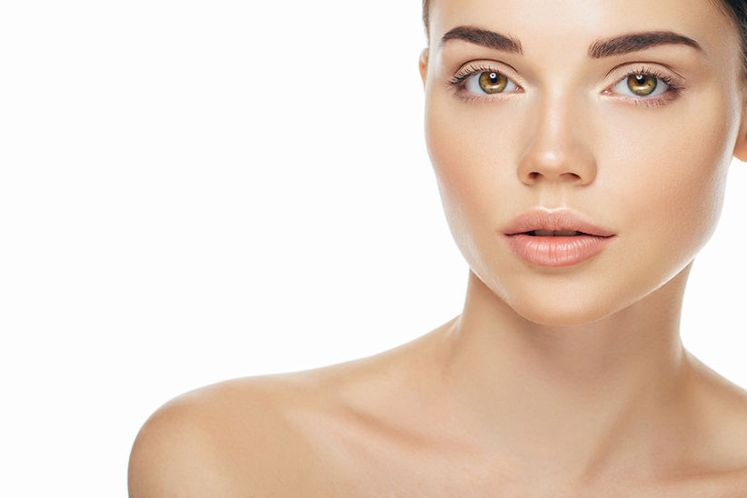 Indoor shot of young beautiful woman on light background