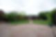 Spare timber is stored in a timber shed wood store in a back garden, laid to lawn with gra