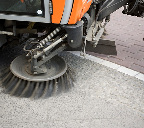 A close-up of a street cleaning machine
