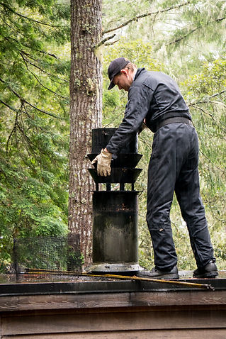 Chimney Sweep cleaning on roof of house cleaning dirty chimney