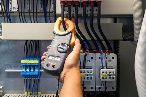 Technician is measuring voltage or current by voltmeter in control panel of power plant