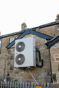 Air source heat pump on home exterior