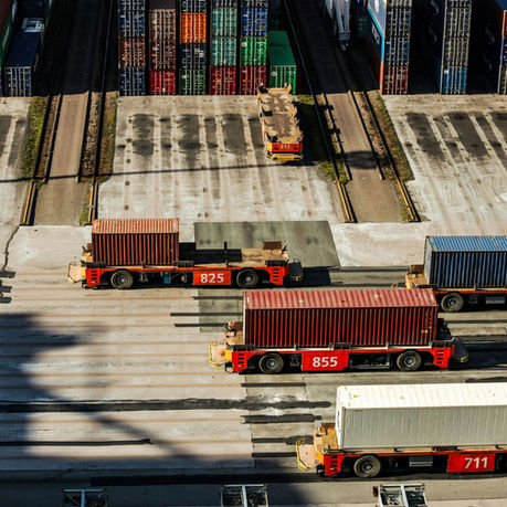 Cargo containers positioned at a shipping yard, representing international trade, freight movement, and supply chain management.
