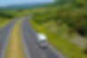 White van travelling along a road in Scotland