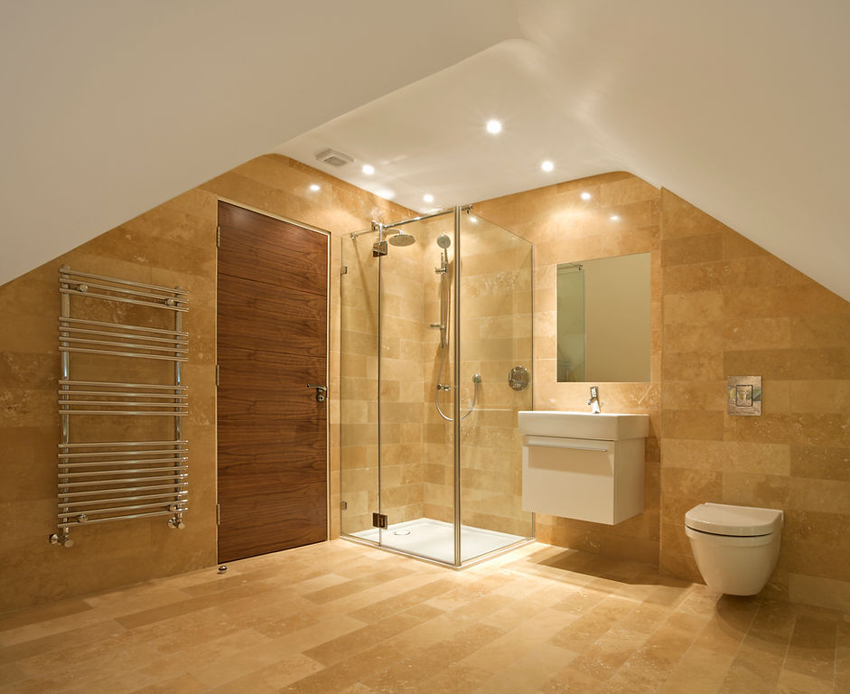 A modern bathroom featuring a glass shower enclosure, a small sink with a mirror above it, wooden accents on the door and walls, and heated towel racks