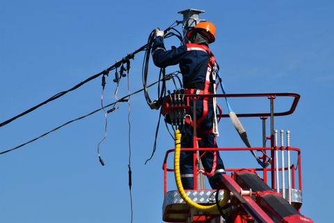 Lineman working on electrical wires from bucket truck