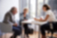 Couple Sitting with Financial Advisor