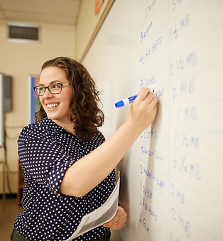 Teacher writing in whiteboard
