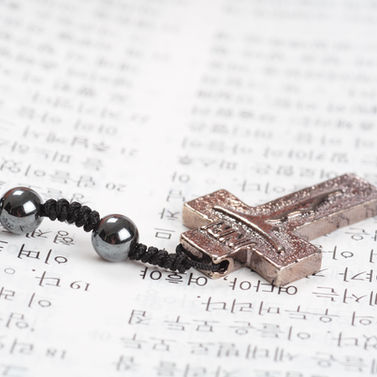cross jewellery made of copper on a silver chain
