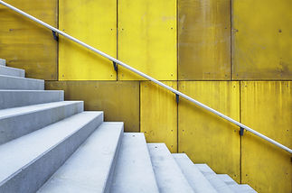 staircase with a yellow wall in the background