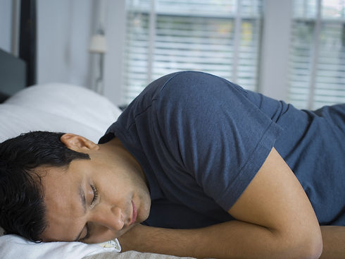 Close-up of a man sleeping on a bed
