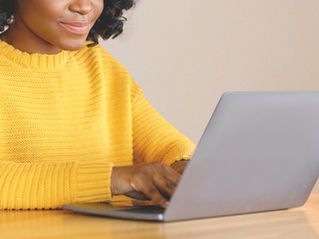 A women searching on a laptop for a local funeral director