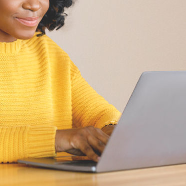 A woman typing on a laptop