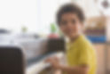 Young boy playing the piano and smiling