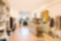 Boutique shop interior with beige units, vintage decor and clothing displays