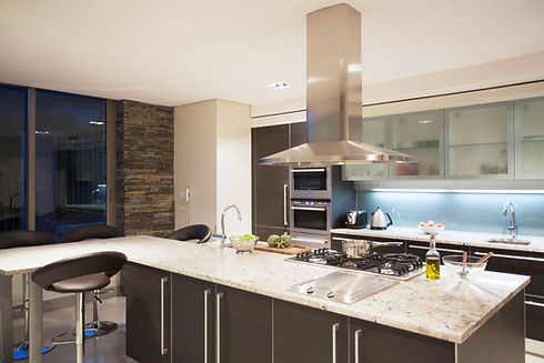 A Modern kitchen featuring a granite countertop and stainless steel appliances