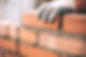 a worker laying bricks