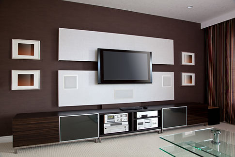 Modern living room with a sleek TV mounted on a brown and white accent wall