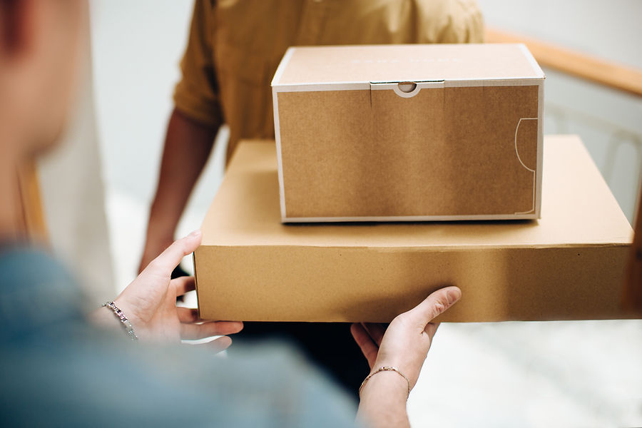 Man opening door to courier delivering parcels