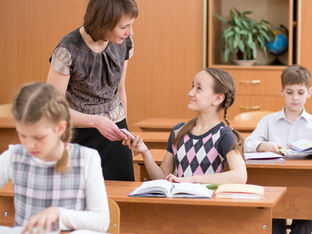 A teacher catching a student cheating.