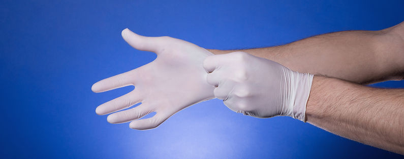 Putting on latex gloves