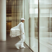 Worker Carrying Linens