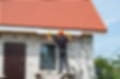 A professional installing a guttering system on a house