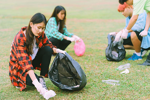 Group of Asian picking up trash in a park