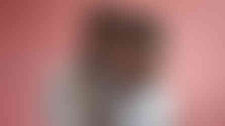 A mother and son hugging and smiling as their photo is being taken.